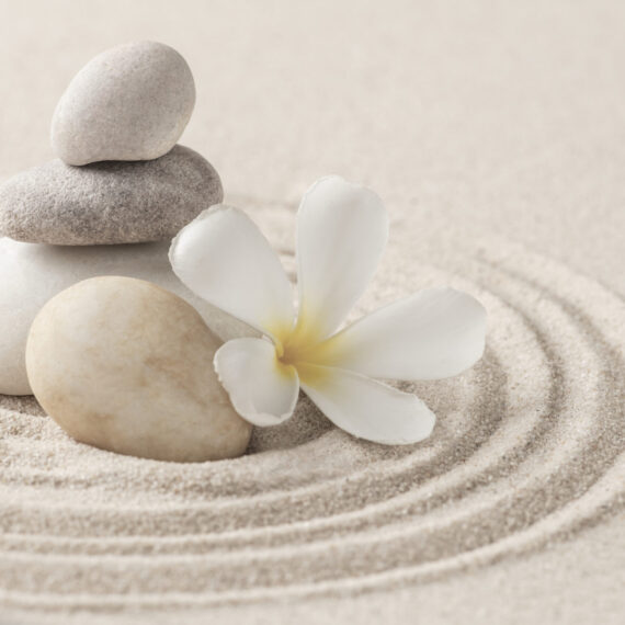 Stacked zen stones sand background art of balance concept
